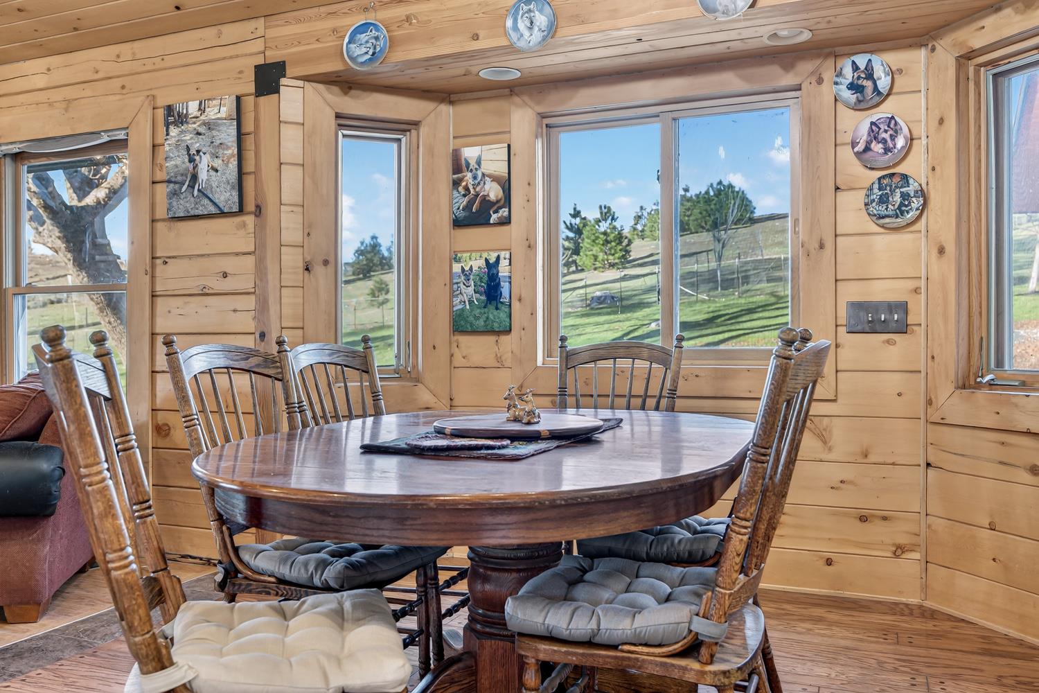10394 Ponderosa Way Mountain Ranch, CA 95246 - Photo 8 of 58 a view of a dining room with furniture large windows and wooden floor