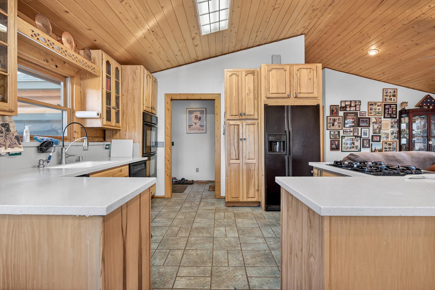 10394 Ponderosa Way Mountain Ranch, CA 95246 - Photo 10 of 58 a kitchen with stainless steel appliances a sink stove and refrigerator