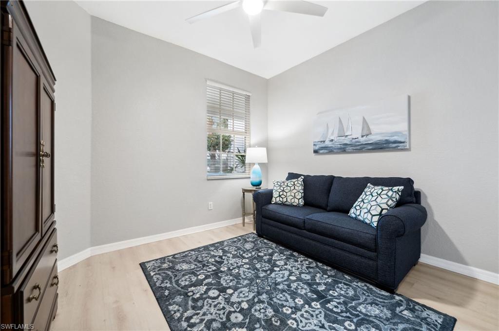 8355 Whisper Trace Lane, Unit K104 Naples, FL 34114 - Photo 12 of 21 a living room with a couch and a rug