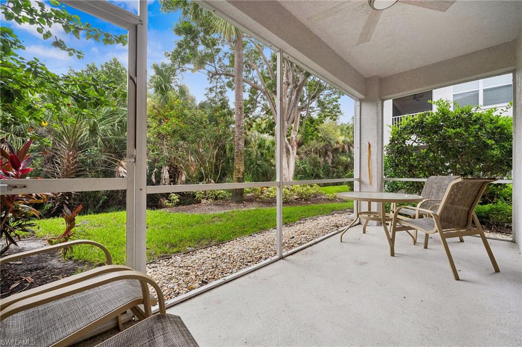 8355 Whisper Trace Lane, Unit K104 Naples, FL 34114 - Photo 14 of 21 a view of a porch with furniture and garden