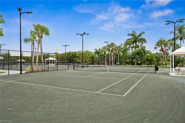 a front view of a house with a yard and potted plants