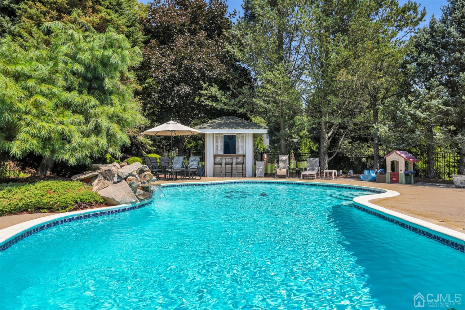 2 Astor Drive Manalapan, NJ 07726 - Photo 14 of 60 a view of a house with a yard patio and swimming pool