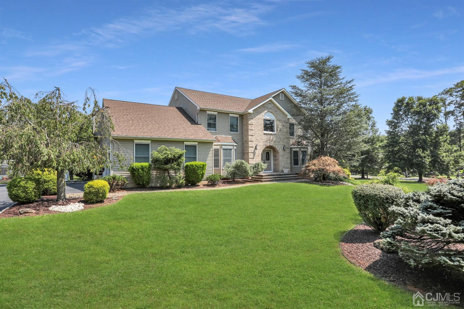 2 Astor Drive Manalapan, NJ 07726 - Photo 3 of 60 a front view of a house with garden