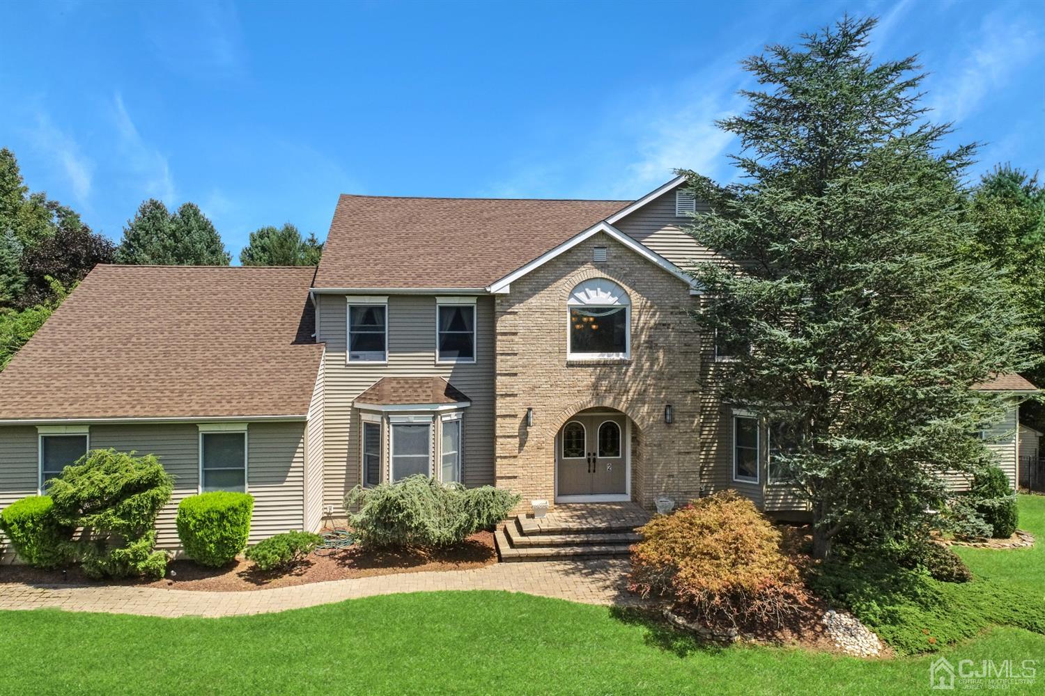 2 Astor Drive Manalapan, NJ 07726 - Photo 21 of 60 a front view of a house with a yard and garage