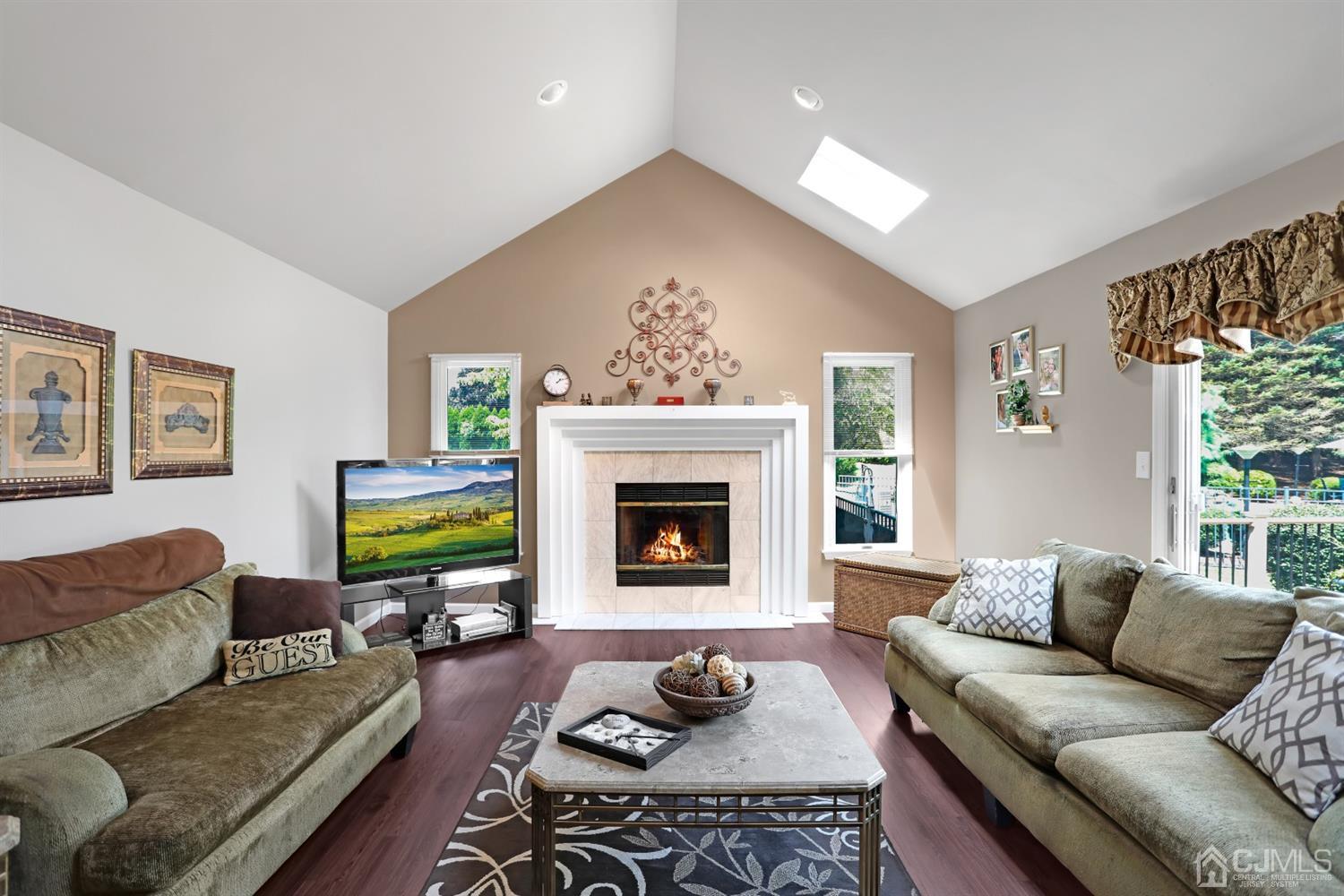 2 Astor Drive Manalapan, NJ 07726 - Photo 29 of 60 a living room with furniture and a fireplace