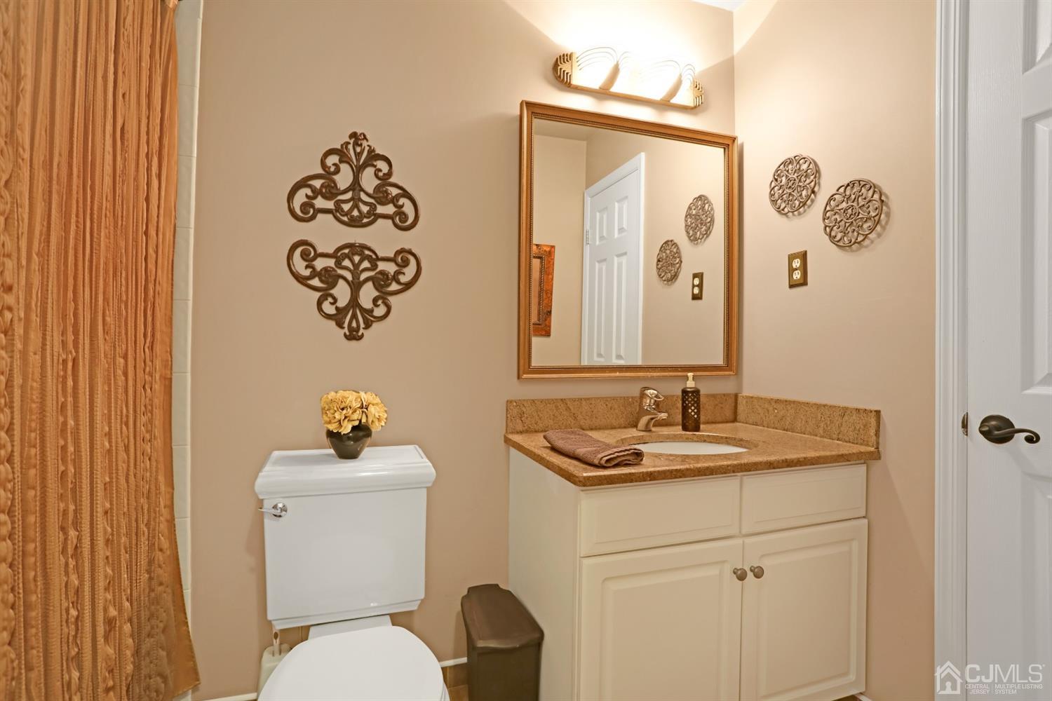 2 Astor Drive Manalapan, NJ 07726 - Photo 33 of 60 a bathroom with a sink and a mirror