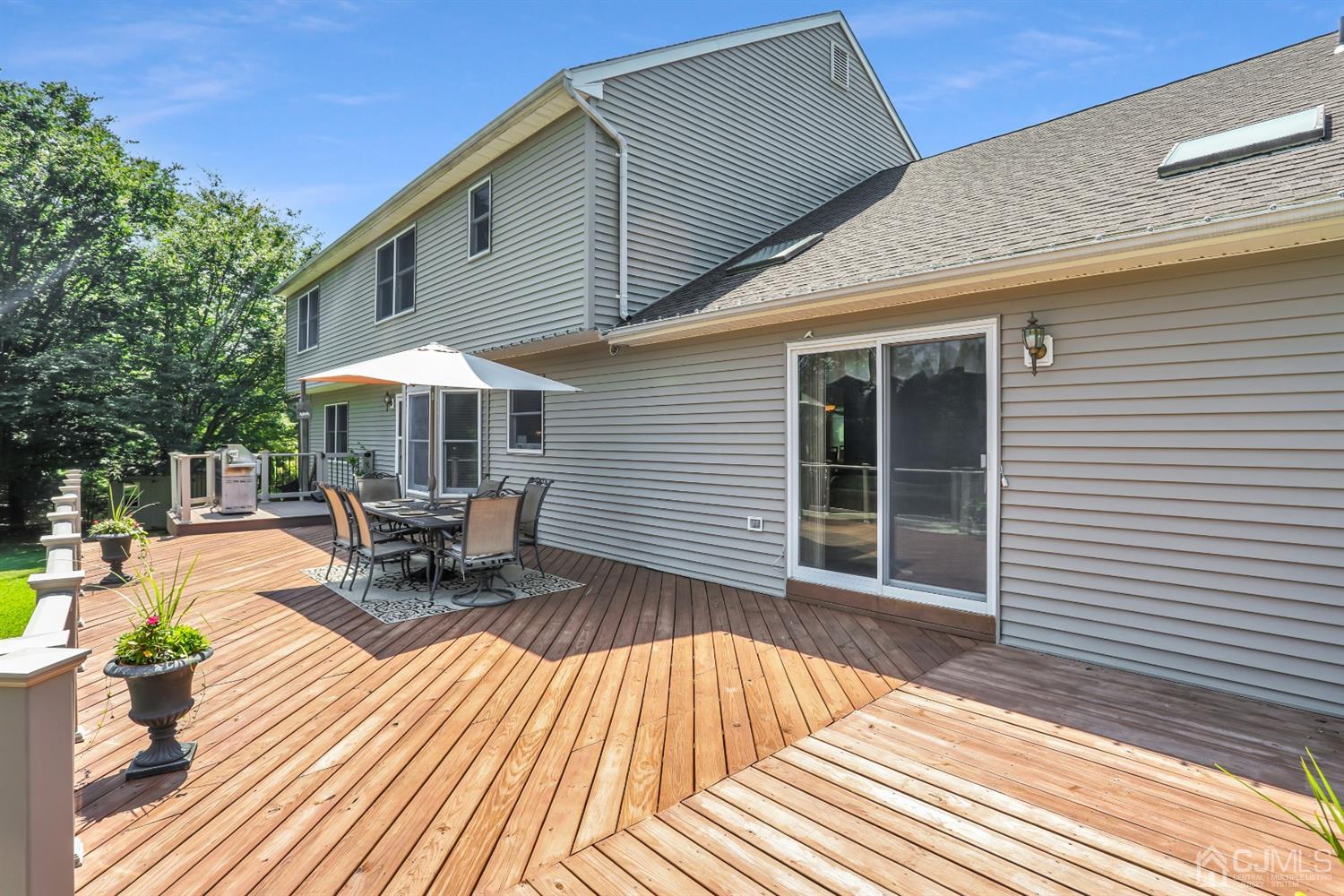2 Astor Drive Manalapan, NJ 07726 - Photo 37 of 60 a view of backyard with a patio and outdoor seating