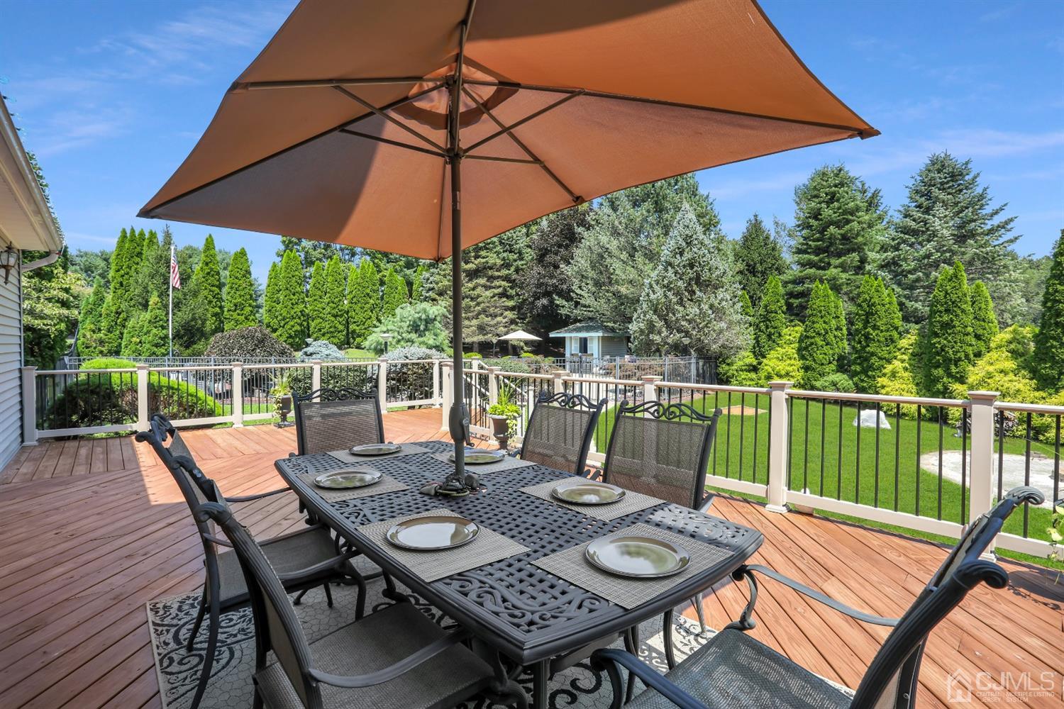 2 Astor Drive Manalapan, NJ 07726 - Photo 39 of 60 a view of deck with furniture and umbrella