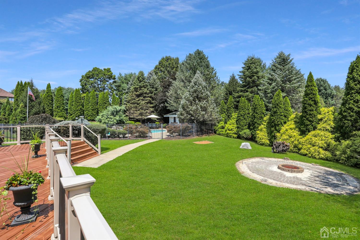 2 Astor Drive Manalapan, NJ 07726 - Photo 40 of 60 a view of a swimming pool with a garden