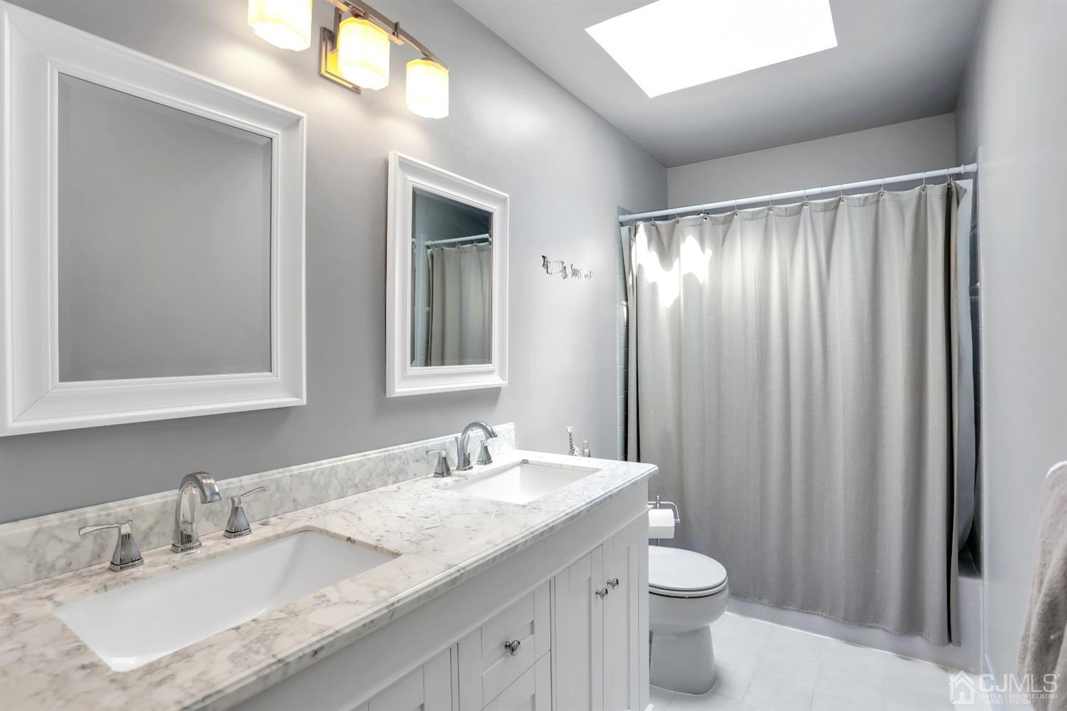 2 Astor Drive Manalapan, NJ 07726 - Photo 51 of 60 a bathroom with a granite countertop sink toilet and shower