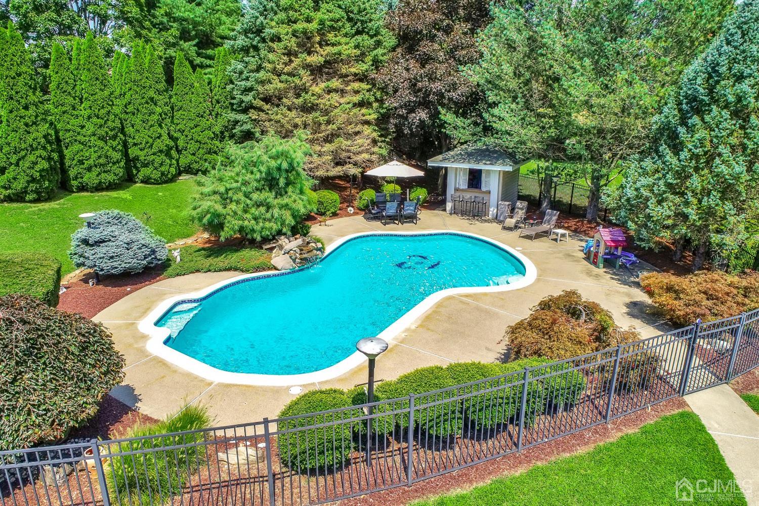 2 Astor Drive Manalapan, NJ 07726 - Photo 10 of 60 a view of a swimming pool and outdoor space