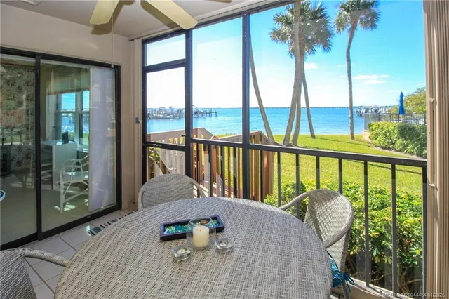 a balcony with furniture and water view