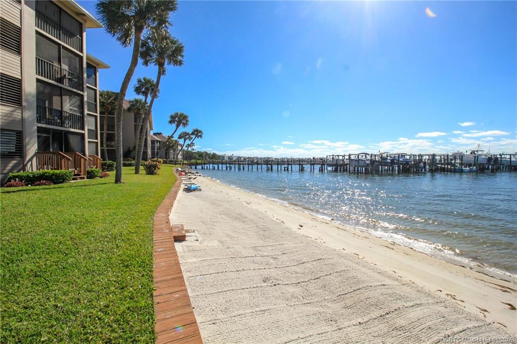 4540 Northeast Sandpebble Trace, Unit 105 Stuart, FL 34996 - Photo 17 of 39 a view of a lake with houses with outdoor space