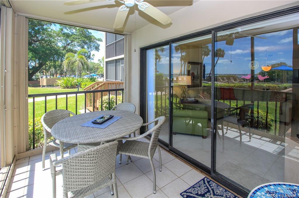 4540 Northeast Sandpebble Trace, Unit 105 Stuart, FL 34996 - Photo 26 of 39 a view of a dining room with furniture window and outside view