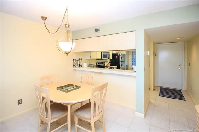 a kitchen with a table and chairs