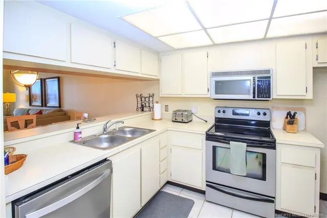a kitchen with a sink stove and microwave