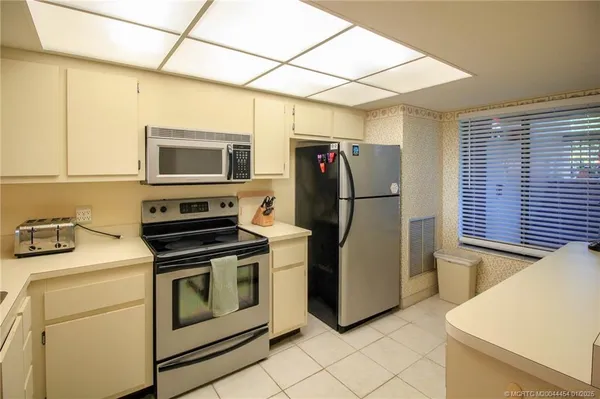a kitchen with a refrigerator stove and microwave