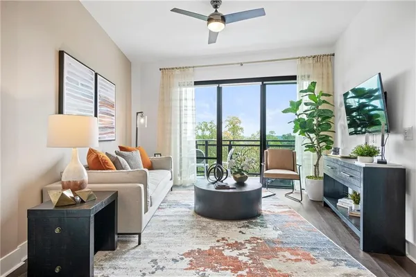 a living room with furniture potted plant and a window