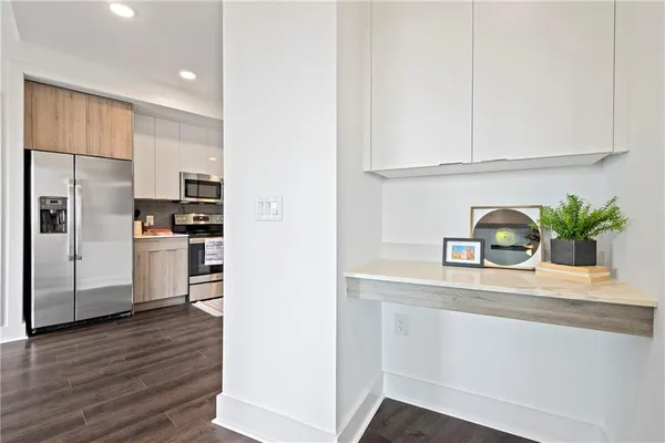 a kitchen with cabinets and stainless steel appliances