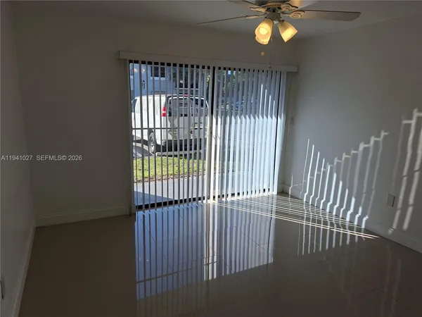a view of a kitchen with refrigerator and microwave
