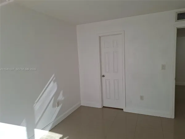 an empty room with closet area