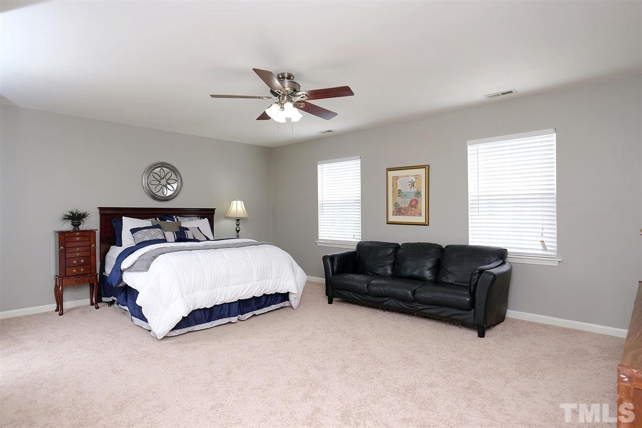 613 Hanson Road Durham, NC 27713 - Photo 16 of 25 a bedroom with a bed couch and window