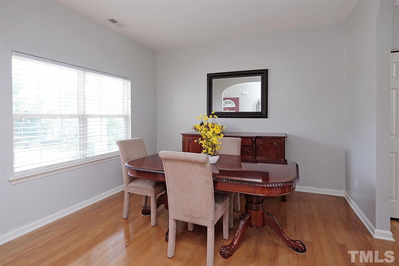613 Hanson Road Durham, NC 27713 - Photo 2 of 25 a view of a dining room with furniture window and wooden floor