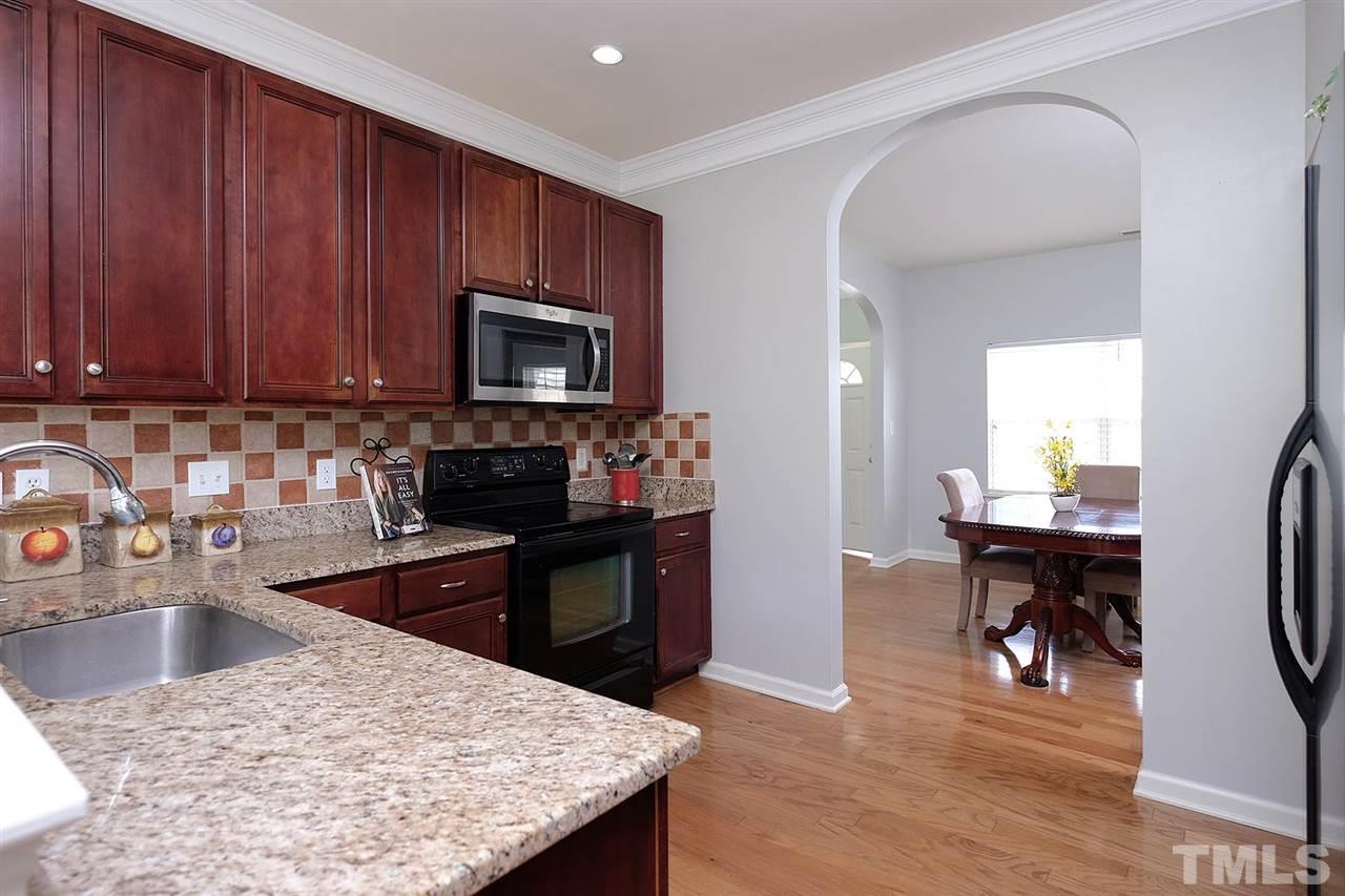 613 Hanson Road Durham, NC 27713 - Photo 4 of 25 a kitchen with a stove a sink and a microwave