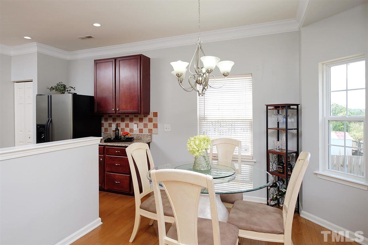 613 Hanson Road Durham, NC 27713 - Photo 6 of 25 a dining room with furniture a chandelier and wooden floor