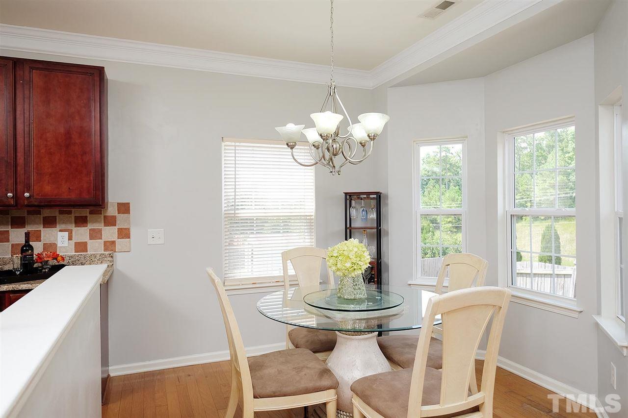 613 Hanson Road Durham, NC 27713 - Photo 7 of 25 a view of a dining room with furniture a chandelier and wooden floor