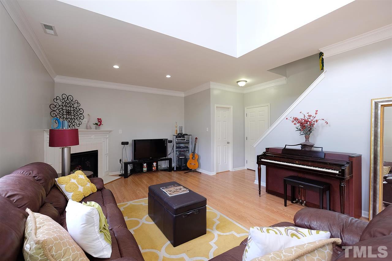 613 Hanson Road Durham, NC 27713 - Photo 9 of 25 a living room with furniture a flat screen tv and a fireplace
