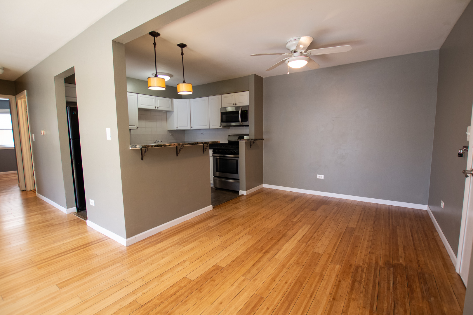 301 Chicago Avenue, Unit 1SW Oak Park, IL 60302 - Photo 4 of 12 a view of a kitchen with a wooden floor and a kitchen