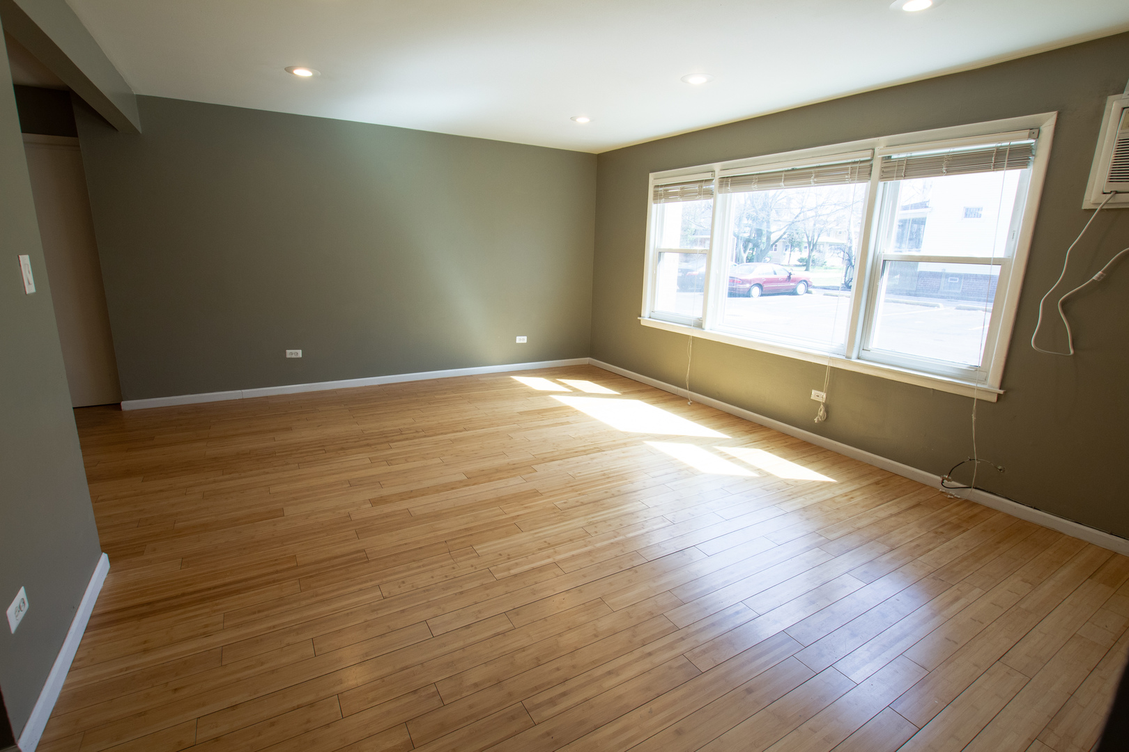 301 Chicago Avenue, Unit 1SW Oak Park, IL 60302 - Photo 7 of 12 an empty room with wooden floor and windows