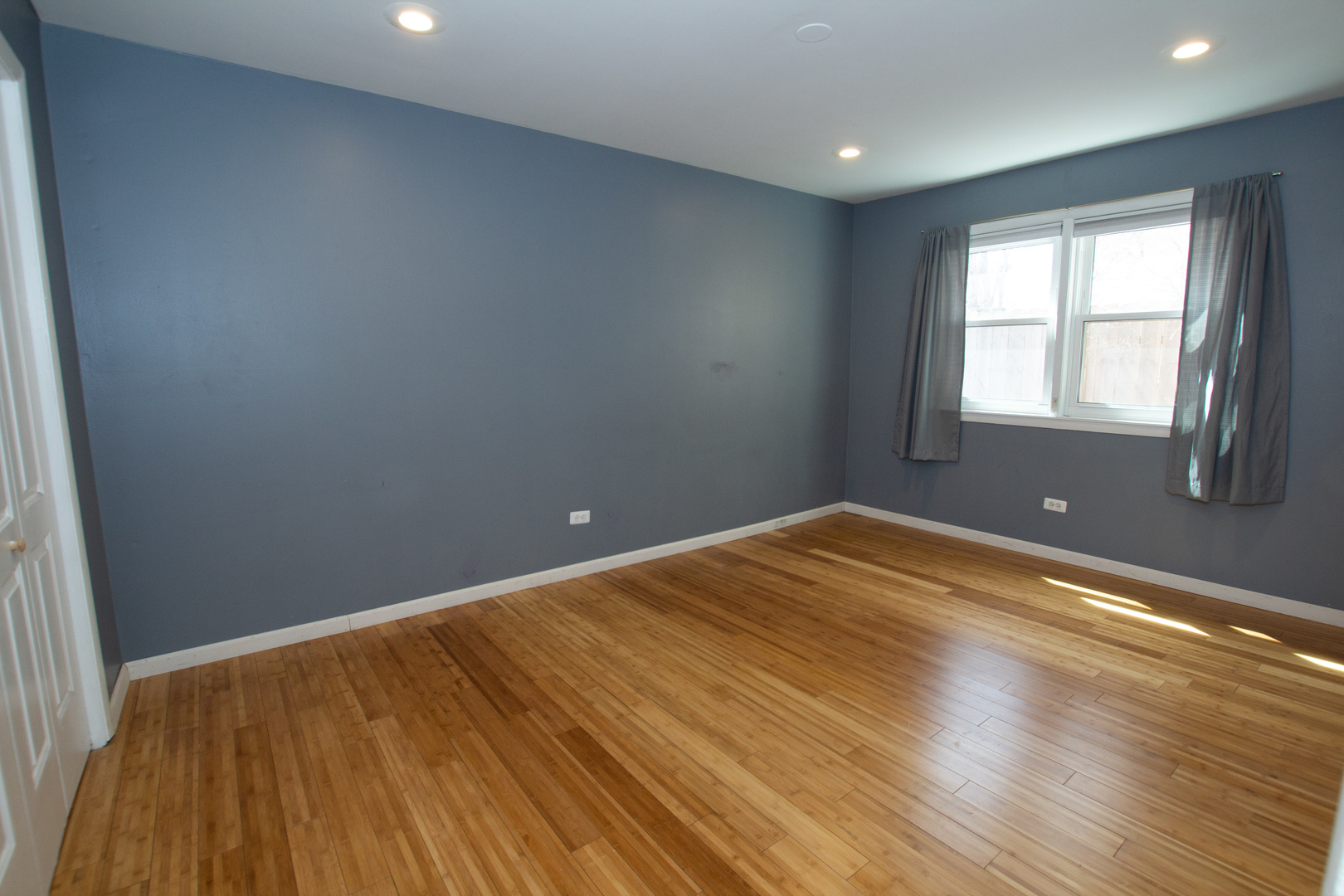 301 Chicago Avenue, Unit 1SW Oak Park, IL 60302 - Photo 8 of 12 an empty room with wooden floor and windows