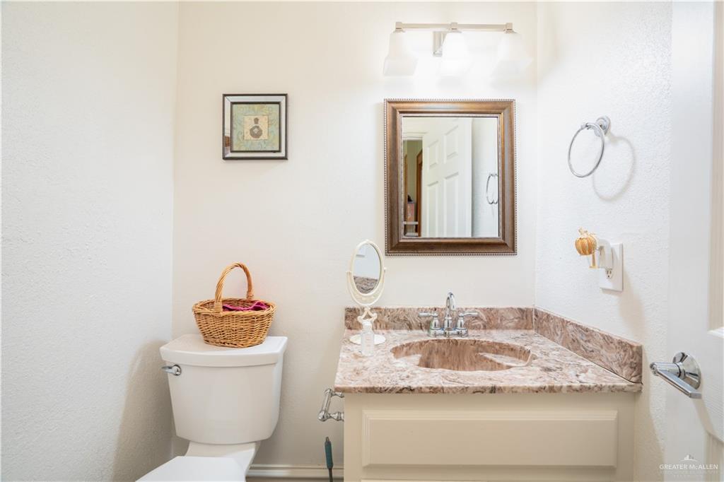 1701 Raul Aguilar Drive Mission, TX 78572 - Photo 12 of 43 a bathroom with a toilet sink and mirror