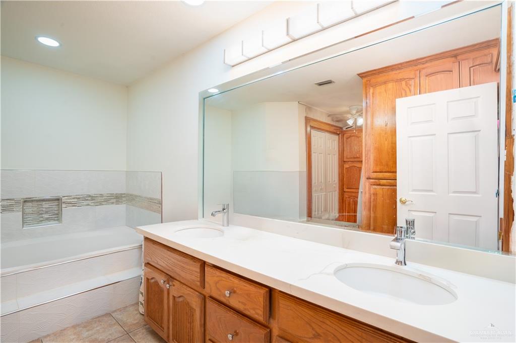 1701 Raul Aguilar Drive Mission, TX 78572 - Photo 15 of 43 a bathroom with a sink and a bathtub