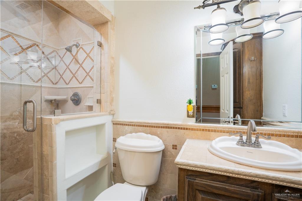 1701 Raul Aguilar Drive Mission, TX 78572 - Photo 17 of 43 a bathroom with a sink and a mirror