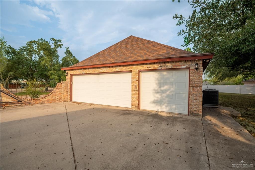 1701 Raul Aguilar Drive Mission, TX 78572 - Photo 28 of 43 a front view of a house with a yard and garage