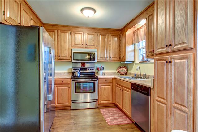 1333 Gen George Patton Road Nashville, TN 37221 - Photo 9 of 20 a kitchen with stainless steel appliances granite countertop a refrigerator sink and stove