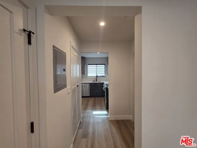 a view of a hallway view with wooden floor and staircase