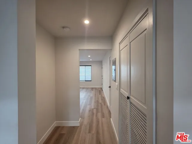 a view of a hallway with wooden floor
