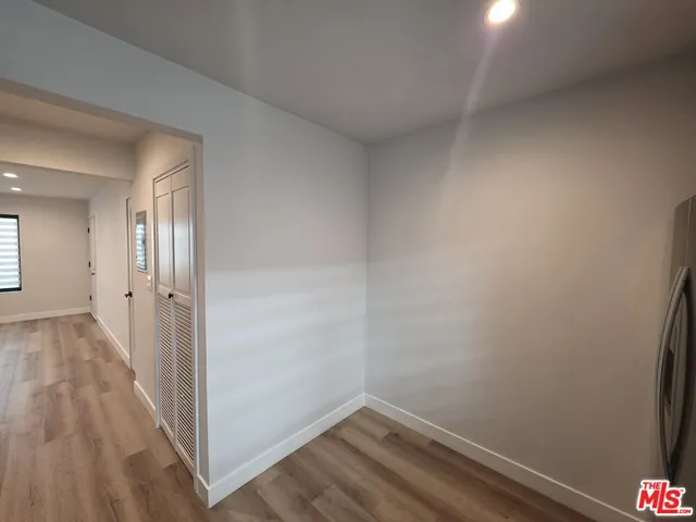 a view of a room with wooden floor