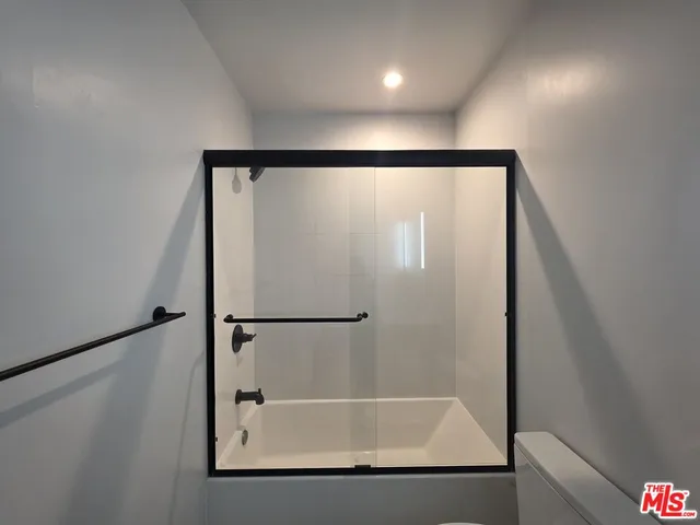 a bathroom with a shower and a mirror