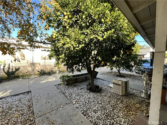 a front view of a house with a tree