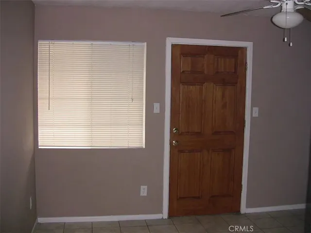 a view of a hallway with wooden shelves