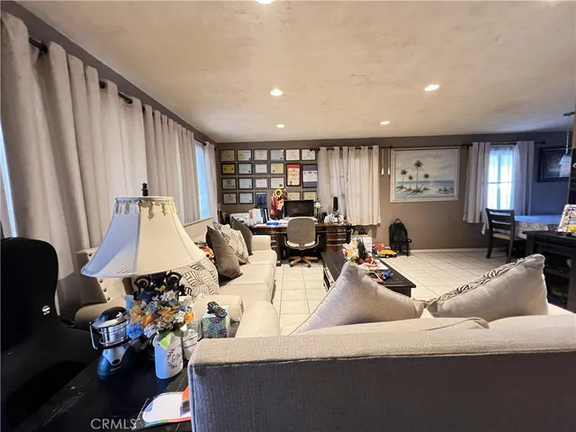 a living room with furniture and large window