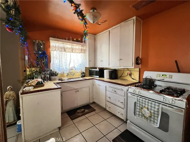 a kitchen with a white cabinets and white appliances