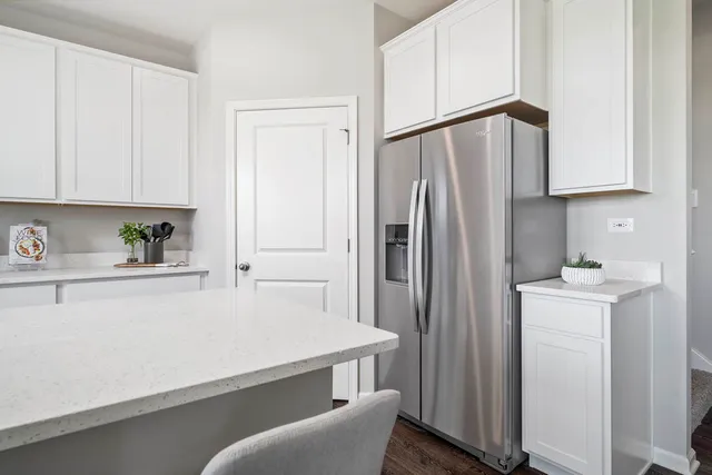 a kitchen with stainless steel appliances a refrigerator sink and cabinets