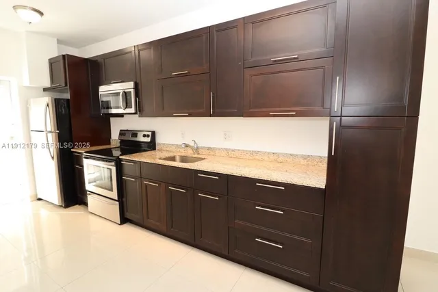 a kitchen with a sink stainless steel appliances and cabinets