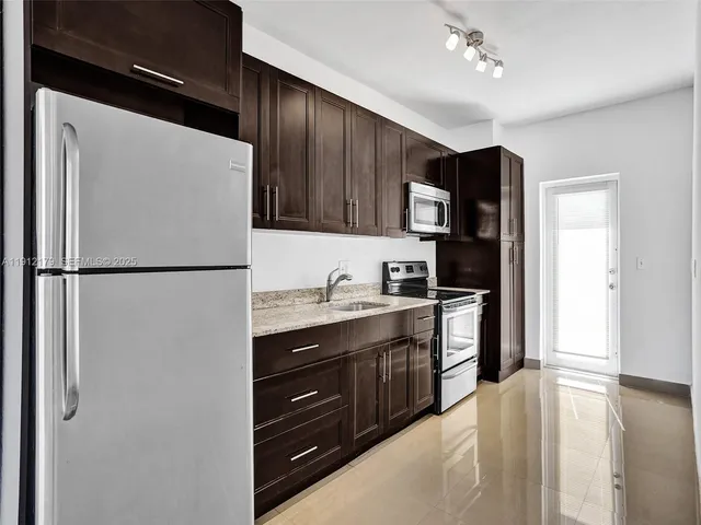 a view of a dry yard with wooden fence